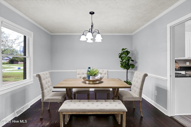 dining room featuring a notable chandelier, dark hardwood / wood-style flooring, ornamental molding, and a textured ceiling