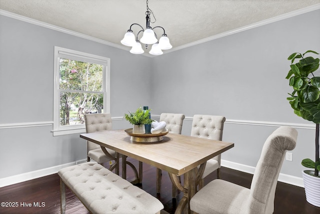 dining space featuring dark hardwood / wood-style flooring, ornamental molding, a textured ceiling, and a chandelier