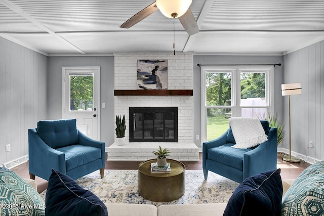 living room with hardwood / wood-style floors, a brick fireplace, and ceiling fan