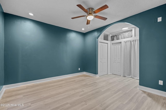 unfurnished bedroom with ceiling fan, a textured ceiling, and light hardwood / wood-style flooring