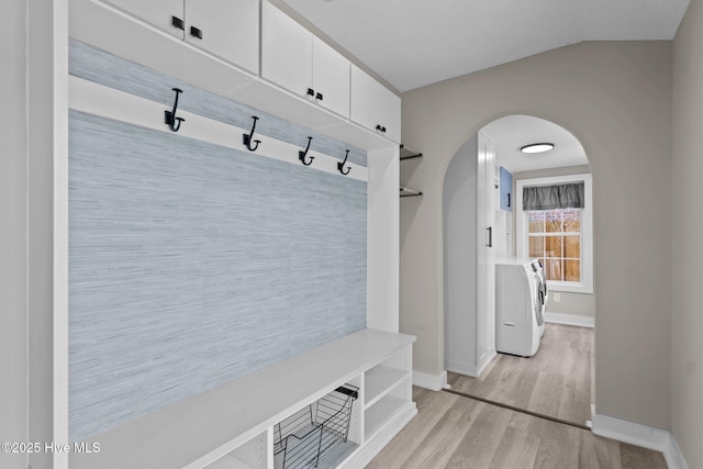 mudroom featuring washer / clothes dryer, vaulted ceiling, and light hardwood / wood-style flooring