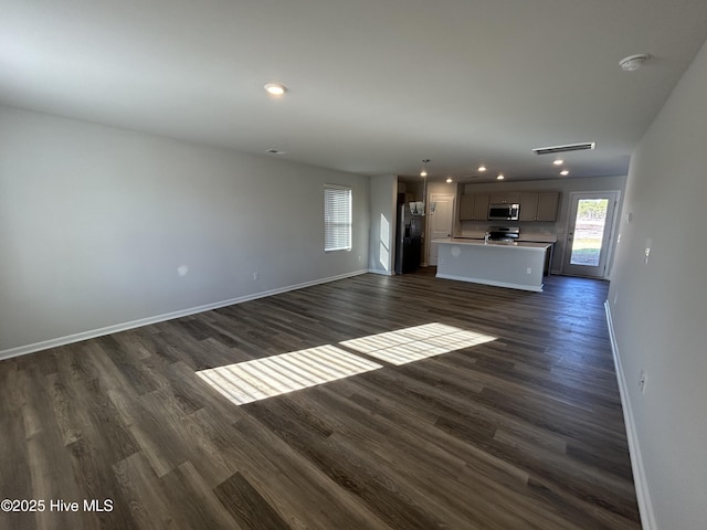 unfurnished living room featuring dark hardwood / wood-style floors