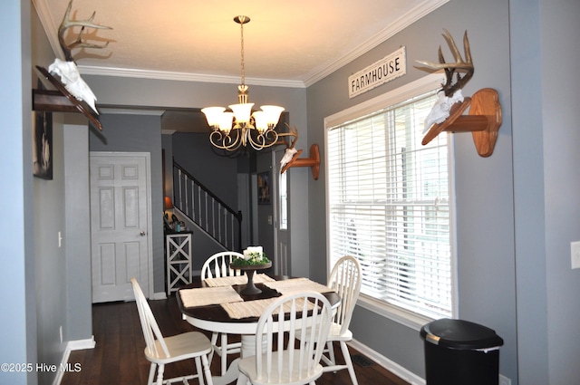 dining space with a wealth of natural light, dark hardwood / wood-style flooring, a chandelier, and ornamental molding