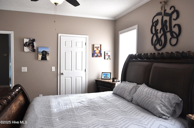 bedroom with ceiling fan and crown molding