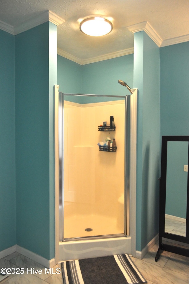 bathroom with a textured ceiling, an enclosed shower, and crown molding