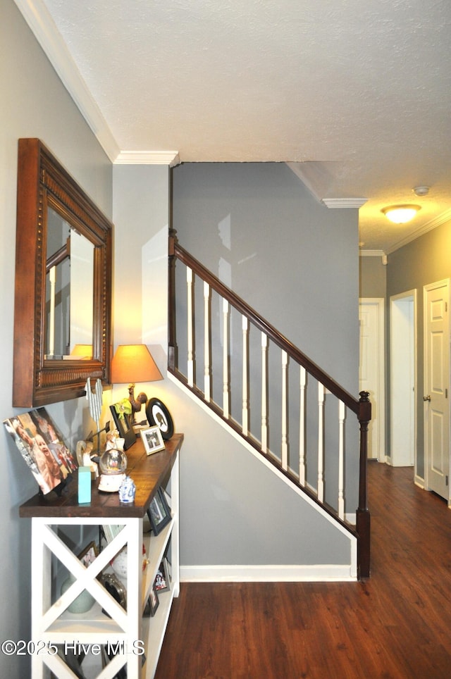 stairway with wood-type flooring and ornamental molding