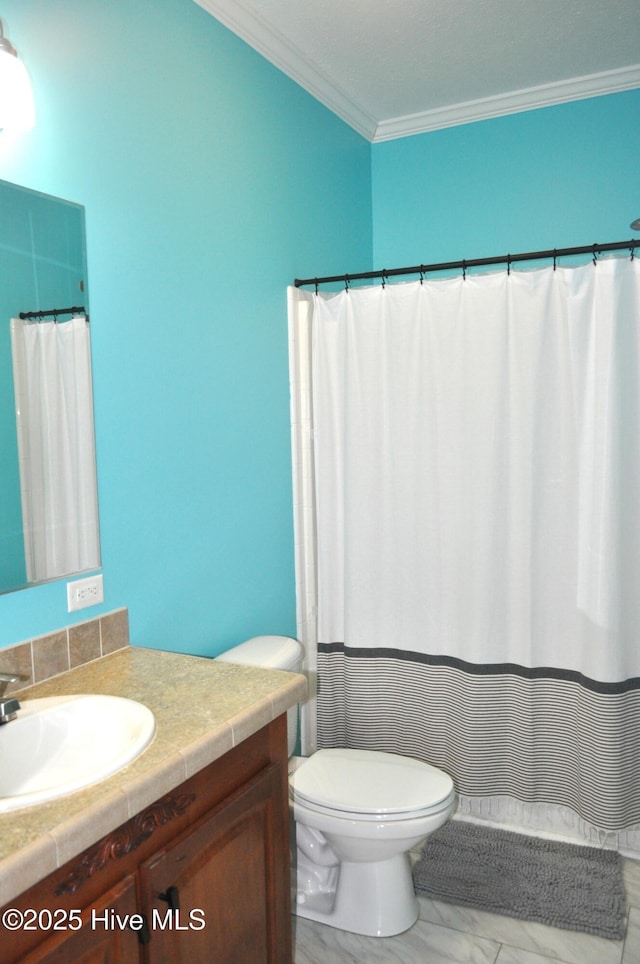 bathroom featuring vanity, toilet, and crown molding