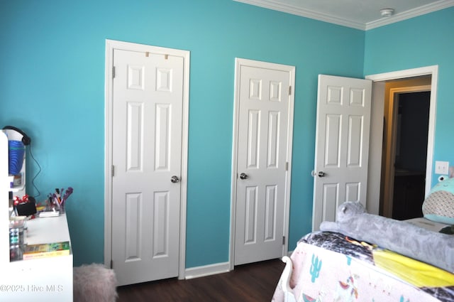 bedroom with dark hardwood / wood-style flooring and ornamental molding