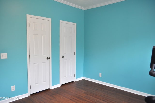 unfurnished bedroom featuring dark hardwood / wood-style floors and crown molding