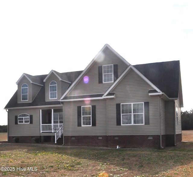 view of front of house featuring covered porch and a front lawn