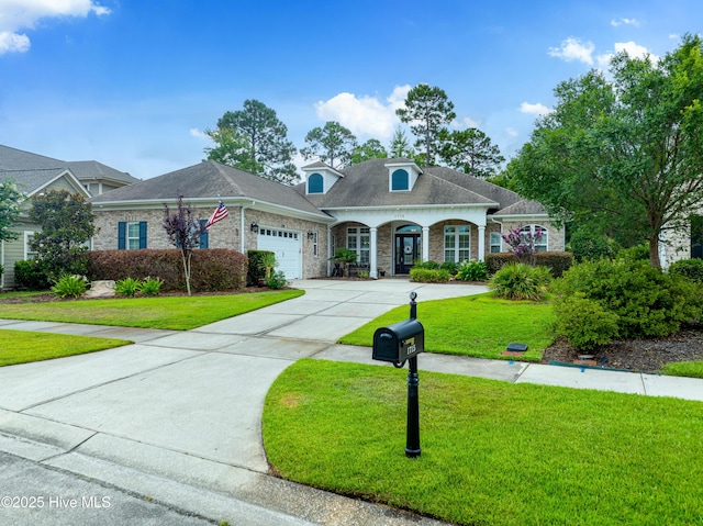 view of front of house featuring a front yard and a garage