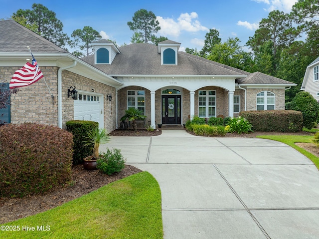 view of front of home with covered porch and a garage