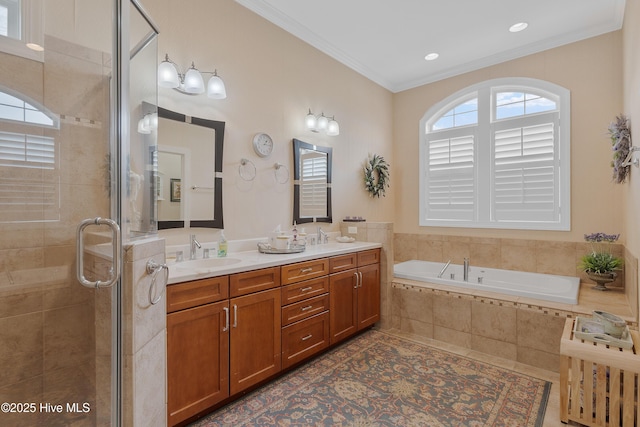 bathroom featuring crown molding, double vanity, a sink, tiled shower, and a bath