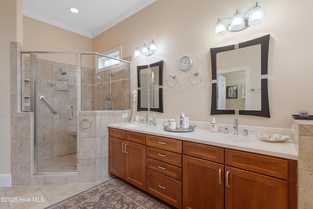 bathroom featuring double vanity, ornamental molding, a sink, and a shower stall