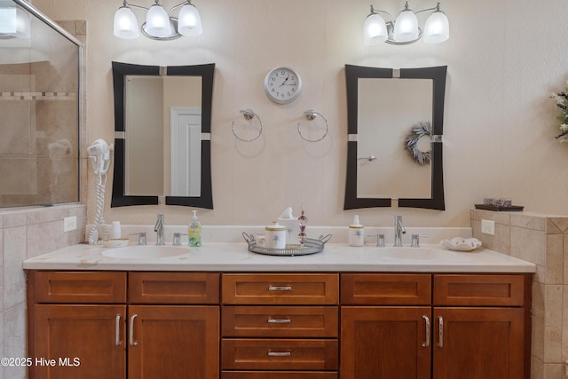 full bathroom featuring a stall shower, a sink, and double vanity