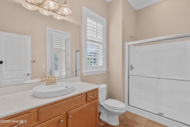 full bathroom with vanity, a shower stall, and toilet