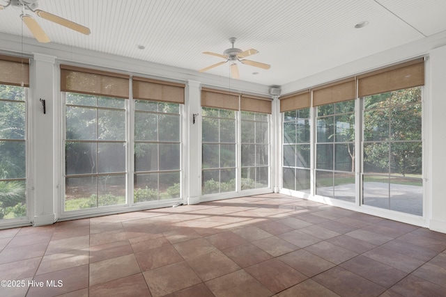 unfurnished sunroom featuring a ceiling fan