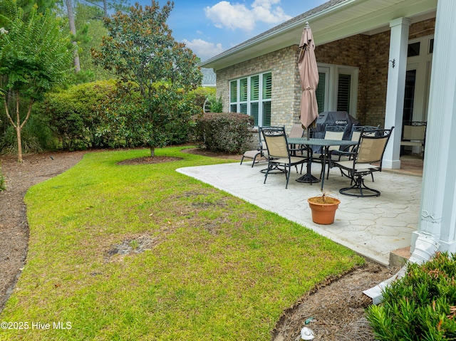 view of yard with outdoor dining area and a patio area