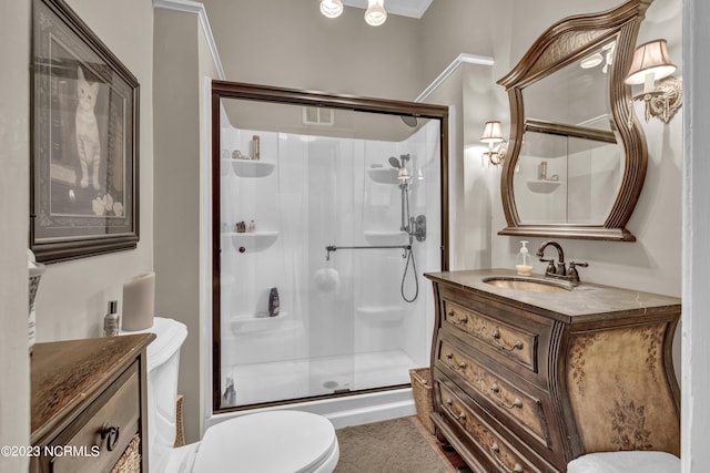 full bath featuring toilet, a shower stall, and vanity