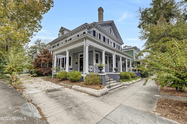 exterior space featuring a porch and a chimney