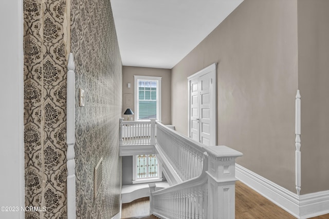 stairs featuring baseboards and wood finished floors