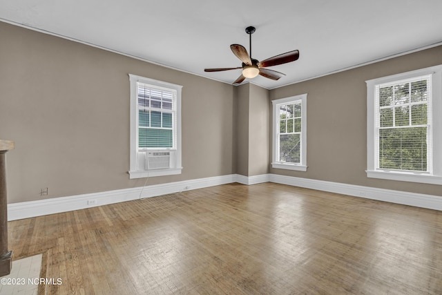 unfurnished room with ornamental molding, hardwood / wood-style floors, ceiling fan, and cooling unit