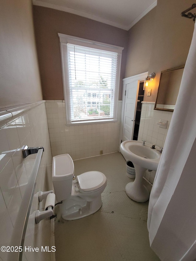 bathroom featuring tile patterned flooring, crown molding, tile walls, and toilet