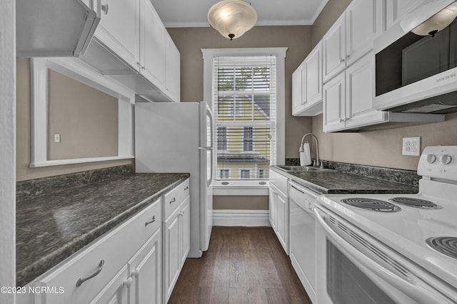 kitchen featuring dark wood finished floors, ornamental molding, white cabinets, a sink, and white appliances