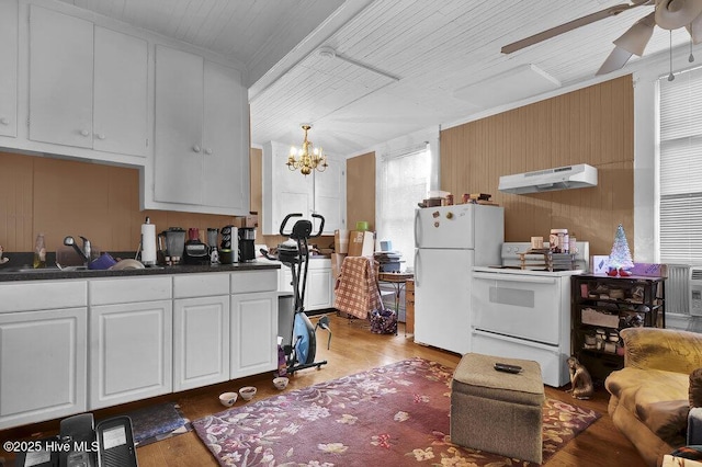 kitchen featuring sink, white appliances, white cabinets, and hardwood / wood-style flooring