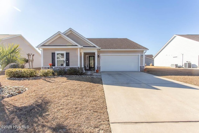 craftsman-style house featuring a garage and cooling unit