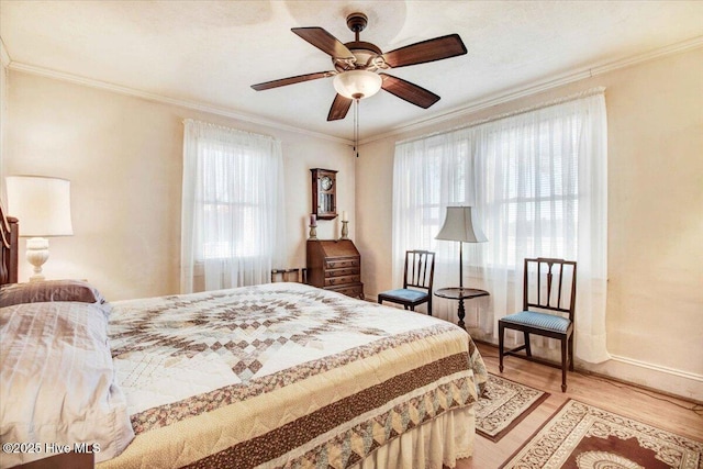 bedroom with ceiling fan, light hardwood / wood-style flooring, and ornamental molding