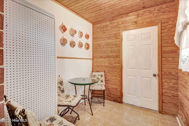 sitting room with wood walls and wood ceiling