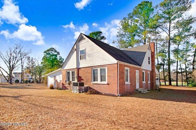 view of side of home with central air condition unit