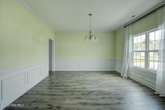 2022 Tarpon Trl, New Bern, NC 28562 - unfurnished dining area with a chandelier, crown molding, wood finished floors, wainscoting, and a decorative wall