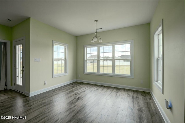 2022 Tarpon Trl, New Bern, NC 28562 - unfurnished dining area with dark wood-style floors, baseboards, and a chandelier