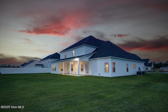 2022 Tarpon Trl, New Bern, NC 28562 - back of house at dusk with central AC unit and a shingled roof