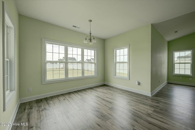 2022 Tarpon Trl, New Bern, NC 28562 - unfurnished dining area featuring a chandelier, wood finished floors, baseboards, and vaulted ceiling