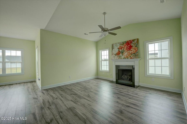 2022 Tarpon Trl, New Bern, NC 28562 - unfurnished living room featuring lofted ceiling, wood finished floors, a ceiling fan, a fireplace, and baseboards