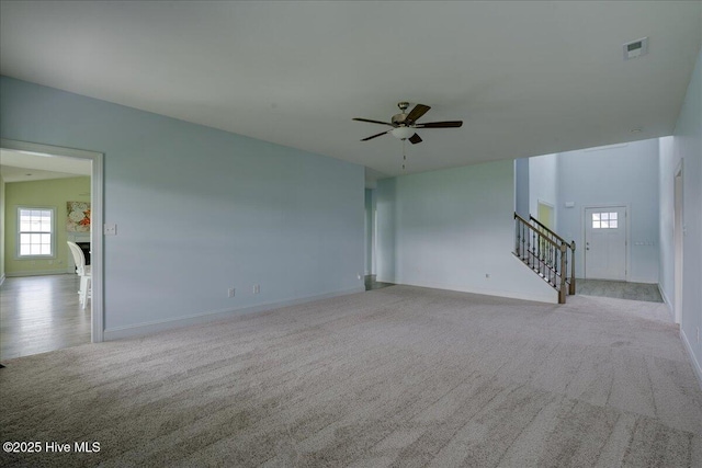 2022 Tarpon Trl, New Bern, NC 28562 - unfurnished living room with carpet floors, stairway, ceiling fan, and baseboards