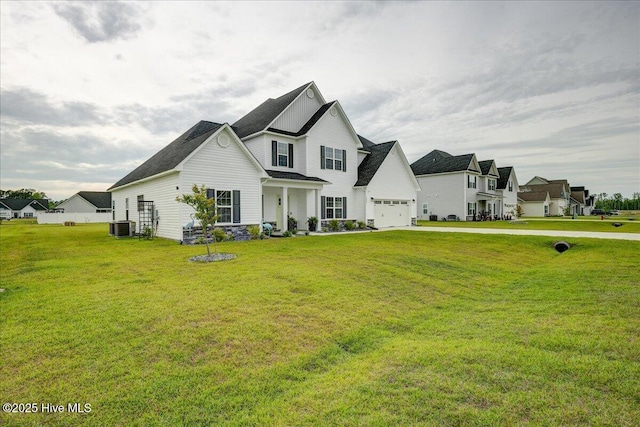 2022 Tarpon Trl, New Bern, NC 28562 - view of front facade with central AC unit, a front yard, driveway, a garage, and a residential view