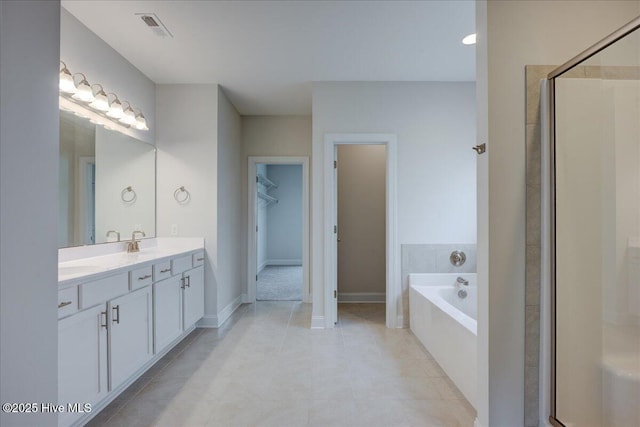 2022 Tarpon Trl, New Bern, NC 28562 - full bath featuring vanity, a bath, a walk in closet, tile patterned floors, and a stall shower