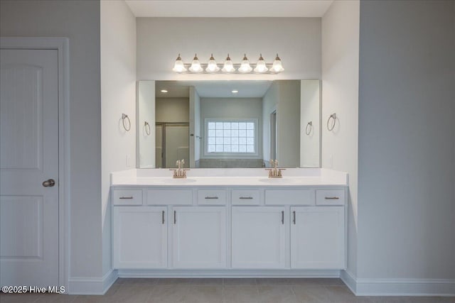 2022 Tarpon Trl, New Bern, NC 28562 - full bath with baseboards, double vanity, a stall shower, and tile patterned flooring