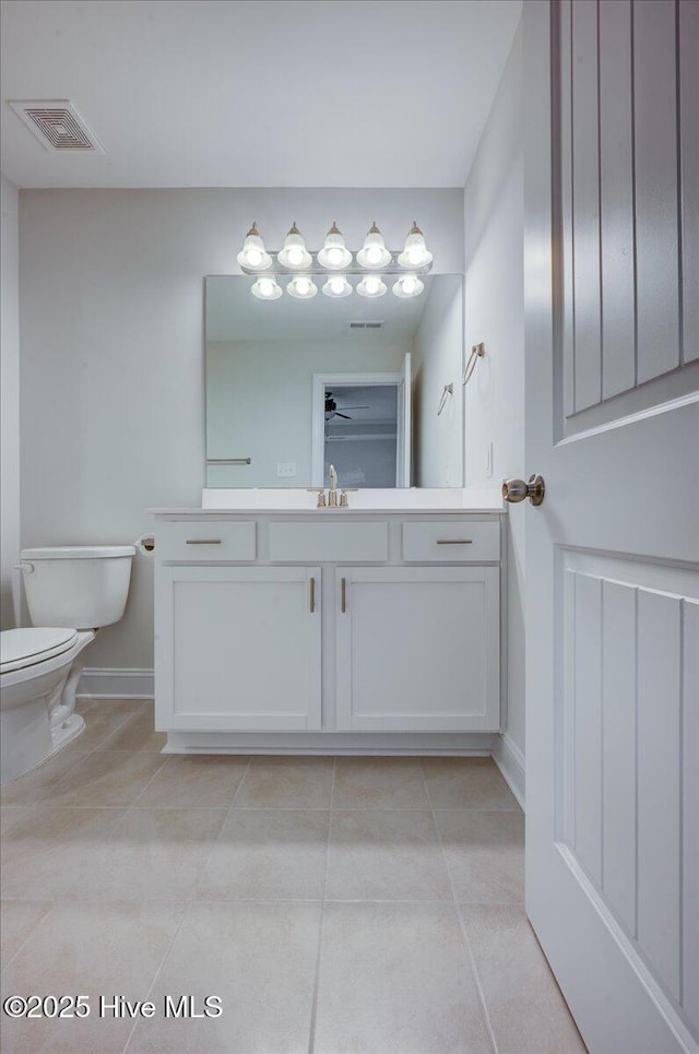 2022 Tarpon Trl, New Bern, NC 28562 - bathroom with tile patterned flooring, toilet, baseboards, vanity, and ceiling fan