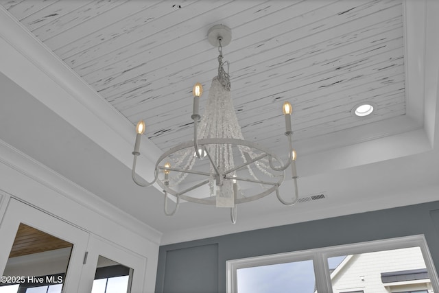 room details with ornamental molding and an inviting chandelier