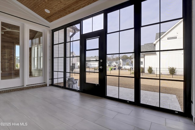 doorway with vaulted ceiling and wooden ceiling