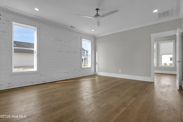 empty room with ceiling fan, ornamental molding, and dark wood-type flooring