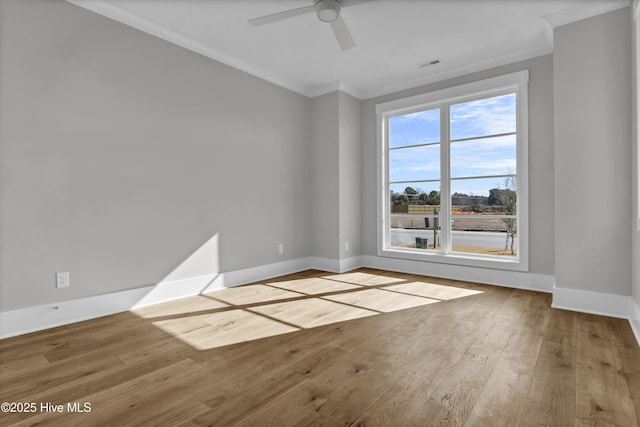 unfurnished room featuring light hardwood / wood-style flooring, ceiling fan, and crown molding