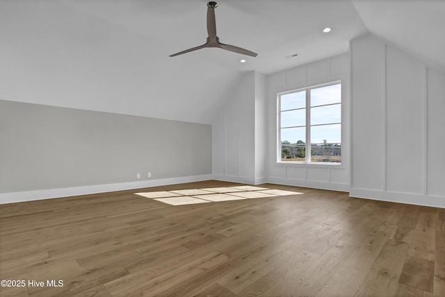 additional living space with ceiling fan, vaulted ceiling, and light wood-type flooring