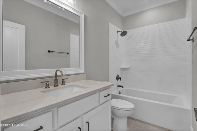 full bathroom with hardwood / wood-style flooring, vanity, toilet, and tiled shower / bath