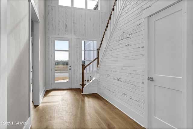 entryway featuring wood walls and light hardwood / wood-style floors